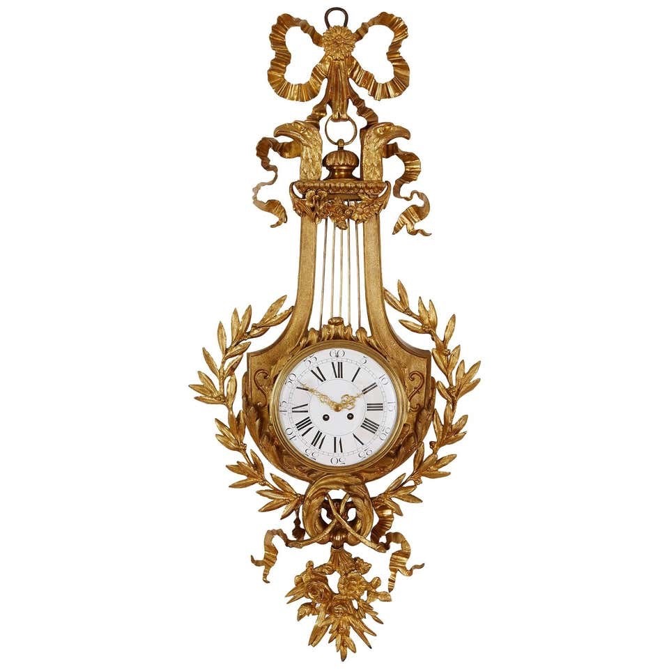 Elegant Neoclassical 19th century Louie XVI style Gilt Bronze Cartel Wall Clock Elegant Neoclassical 19th century Louie XVI style Gilt Bronze Cartel Wall Clock