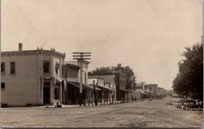 Tiskilwa IL~West Main Street Hitching Posts~Meat Market~Drug Store~1907 RPPC picture